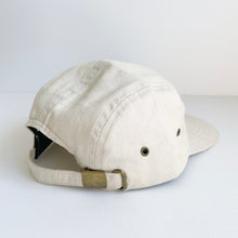 Load image into Gallery viewer, the back of the crew cap patch in cream showing the adjustable strap
