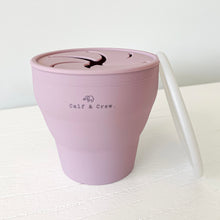 Load image into Gallery viewer, expanded collapsible snack cup with Calf &amp; Crew logo in rose, with a white lid leaning against it
