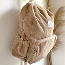 Load image into Gallery viewer, side view of sand corduroy backpack showing the waterbottle pocket and zippered pockets
