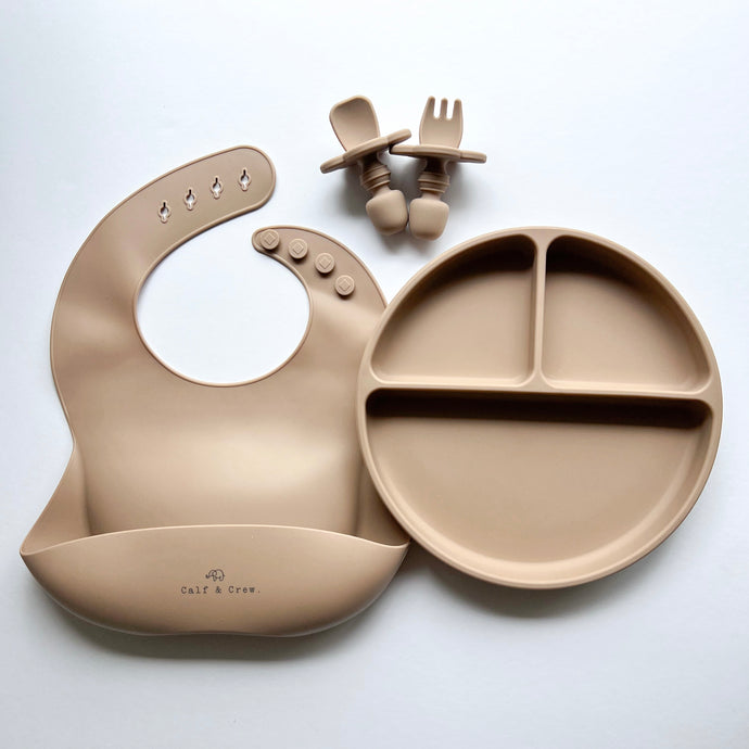 a silicone bib, suction divider plate and easy grip spoon and fork in latte colour