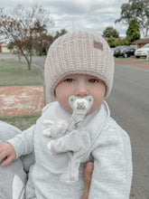 Load image into Gallery viewer, a baby outside wearing the toddler beanie in oatmeal
