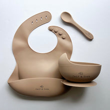 Load image into Gallery viewer, Silicone bib, silicone suction bowl, and silicone spoon in latte colour all with the Calf &amp; Crew logo
