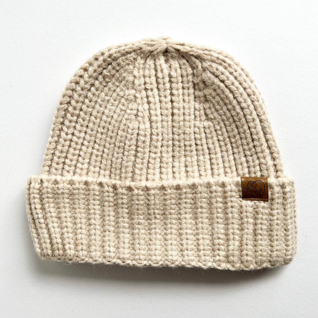 chunky knitted beanie in oatmeal colour with a small elephant logo