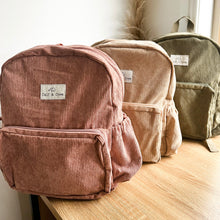 Load image into Gallery viewer, three corduroy junior backpacks in dusty rose, sand and khaki sitting on a wooden table
