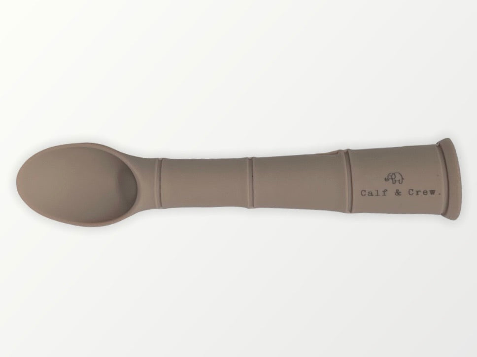 a my first baby spoon in latte silicone with the calf & crew logo