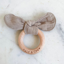 Load image into Gallery viewer, Taupe muslin bunny ear teether ring engraved with Calf &amp; Crew logo
