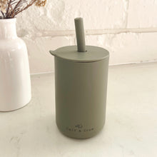 Load image into Gallery viewer, the silicone sippy cup in olive colour showing the calf &amp; crew logo on the bottom of the cup
