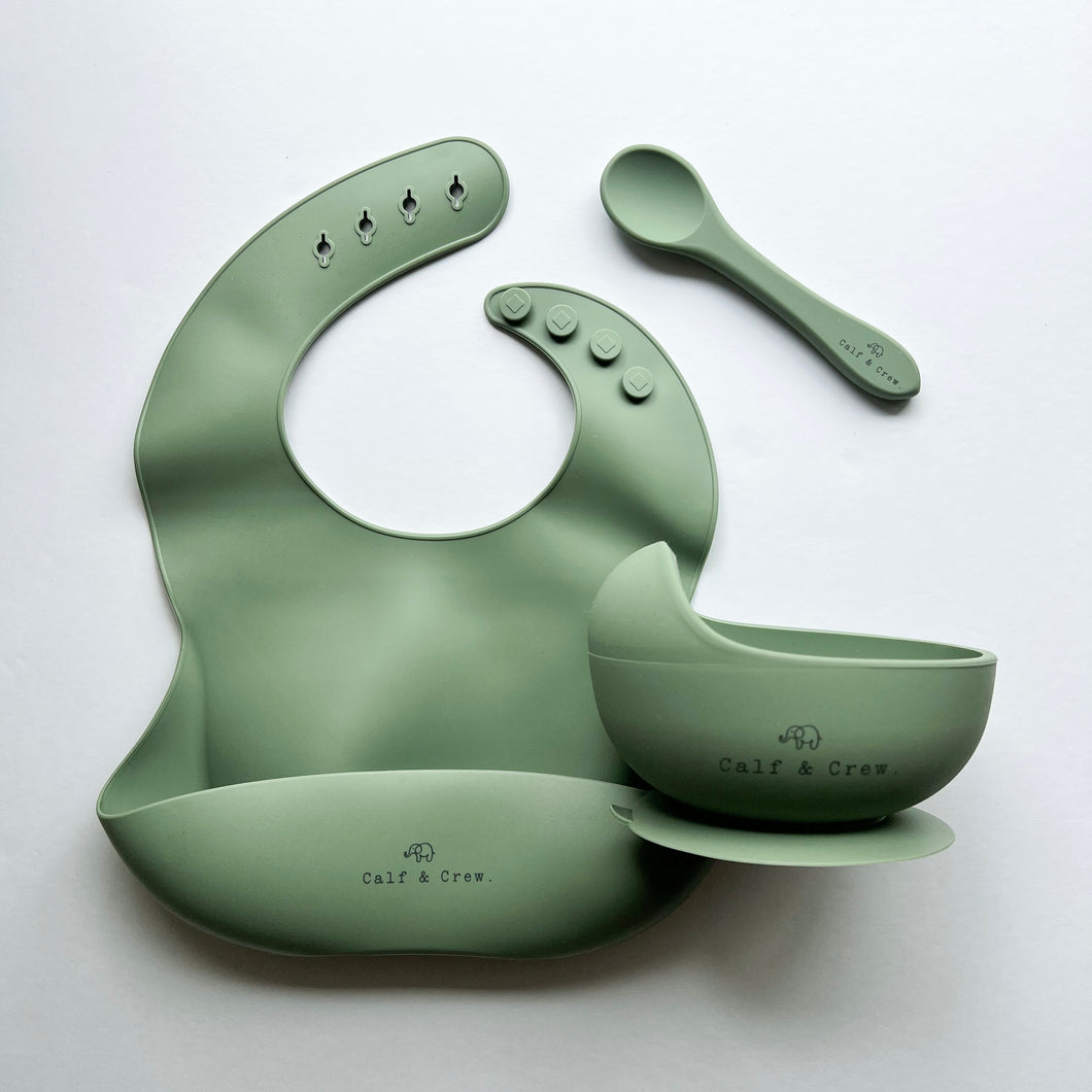 Silicone bib, silicone suction bowl, and silicone spoon in sage colour all with the Calf & Crew logo
