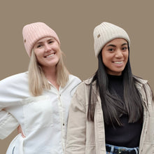 Load image into Gallery viewer, two women wearing the knitted beanies, one wearing blush colour and the other oatmeal colour

