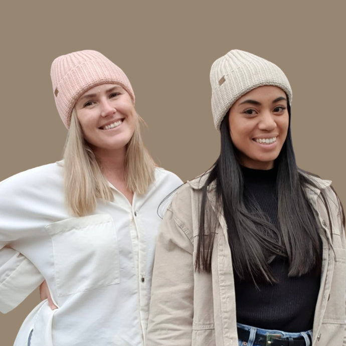 two women wearing the knitted beanies, one wearing blush colour and the other oatmeal colour