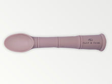 Load image into Gallery viewer, a my first baby spoon in rose silicone with the calf &amp; crew logo
