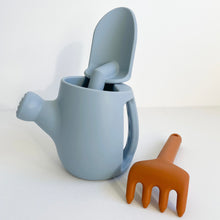 Load image into Gallery viewer, hydrangea silicone garden set with a blue spade inside a blue watering can and a orange rake

