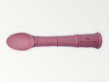 Load image into Gallery viewer, a my first baby spoon in dusty rose silicone with the calf &amp; crew logo
