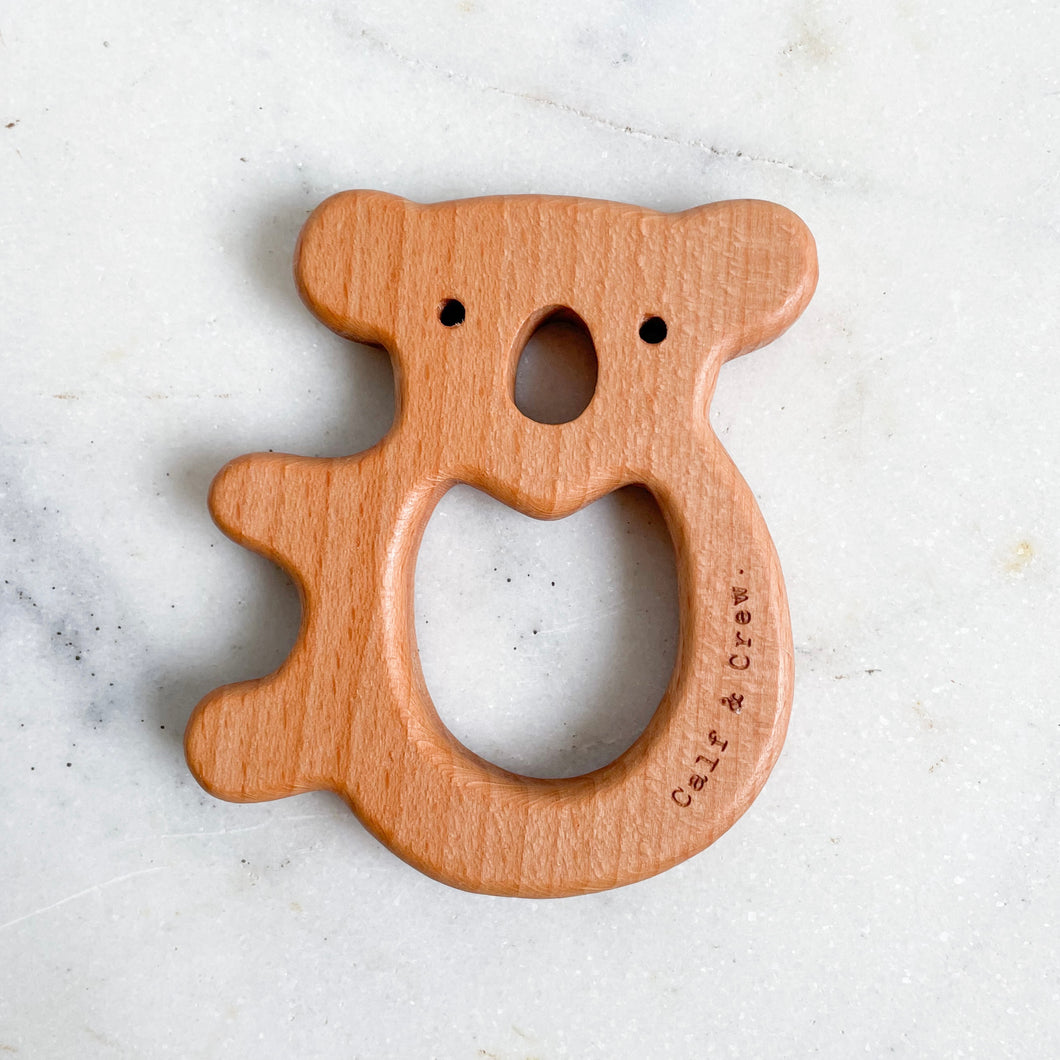 a wooden koala teether with the calf & crew logo engraved on the edge