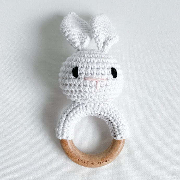 white crochet bunny rattle on a wooden ring