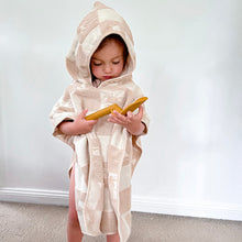 Load image into Gallery viewer, a child wearing the hooded terry beach towel looking at a shovel
