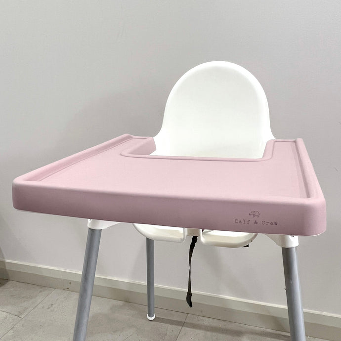 a rose silicone high chair table cover on a white ikea highchair