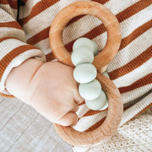 Load image into Gallery viewer, a baby&#39;s hand holding the wooden silicone ring teether in mint colour
