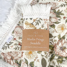 Load image into Gallery viewer, two organic cotton fringe swaddles in secret garden, one laying flat with the other folded in Calf &amp; Crew packaging
